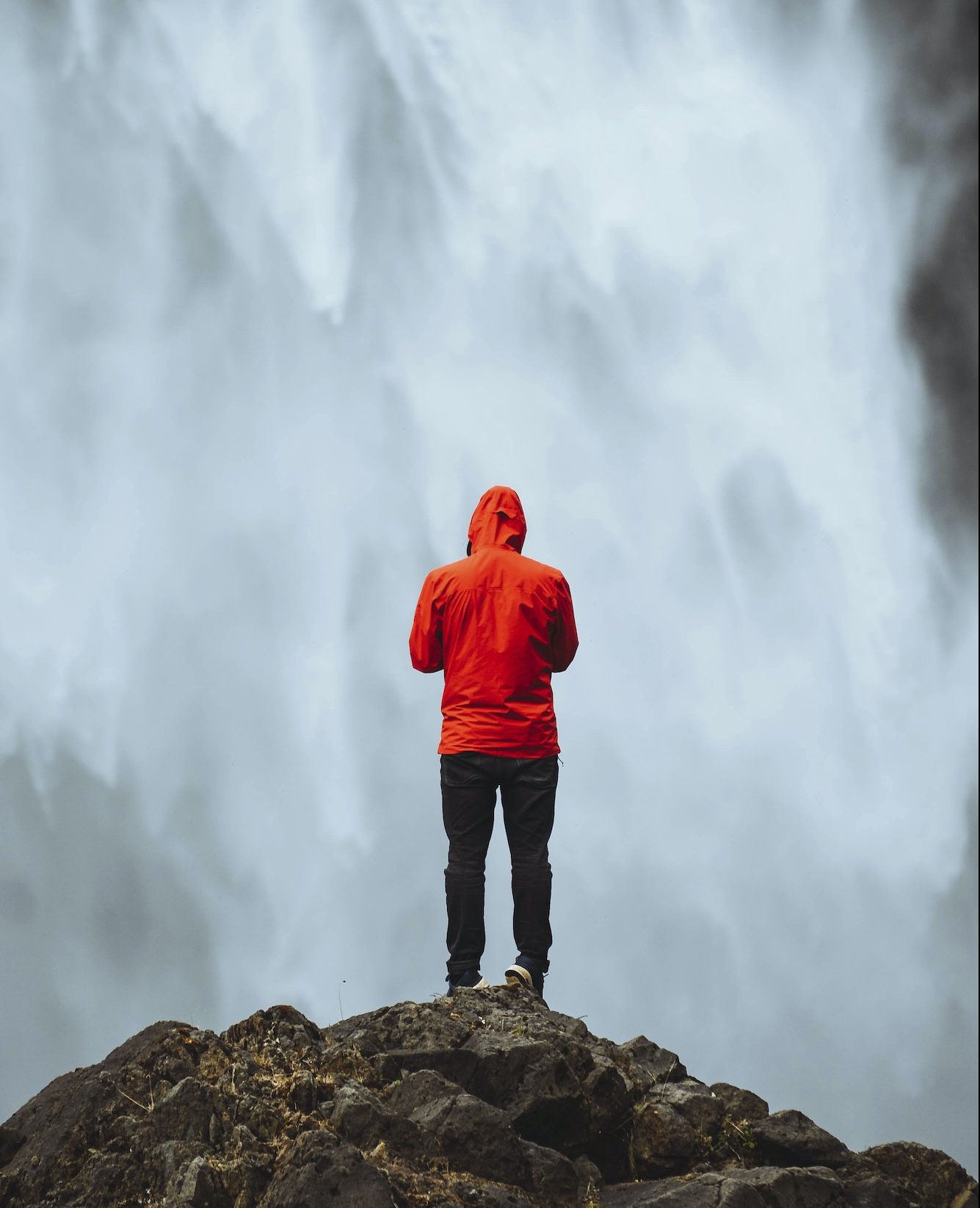 Traveler by a waterfall