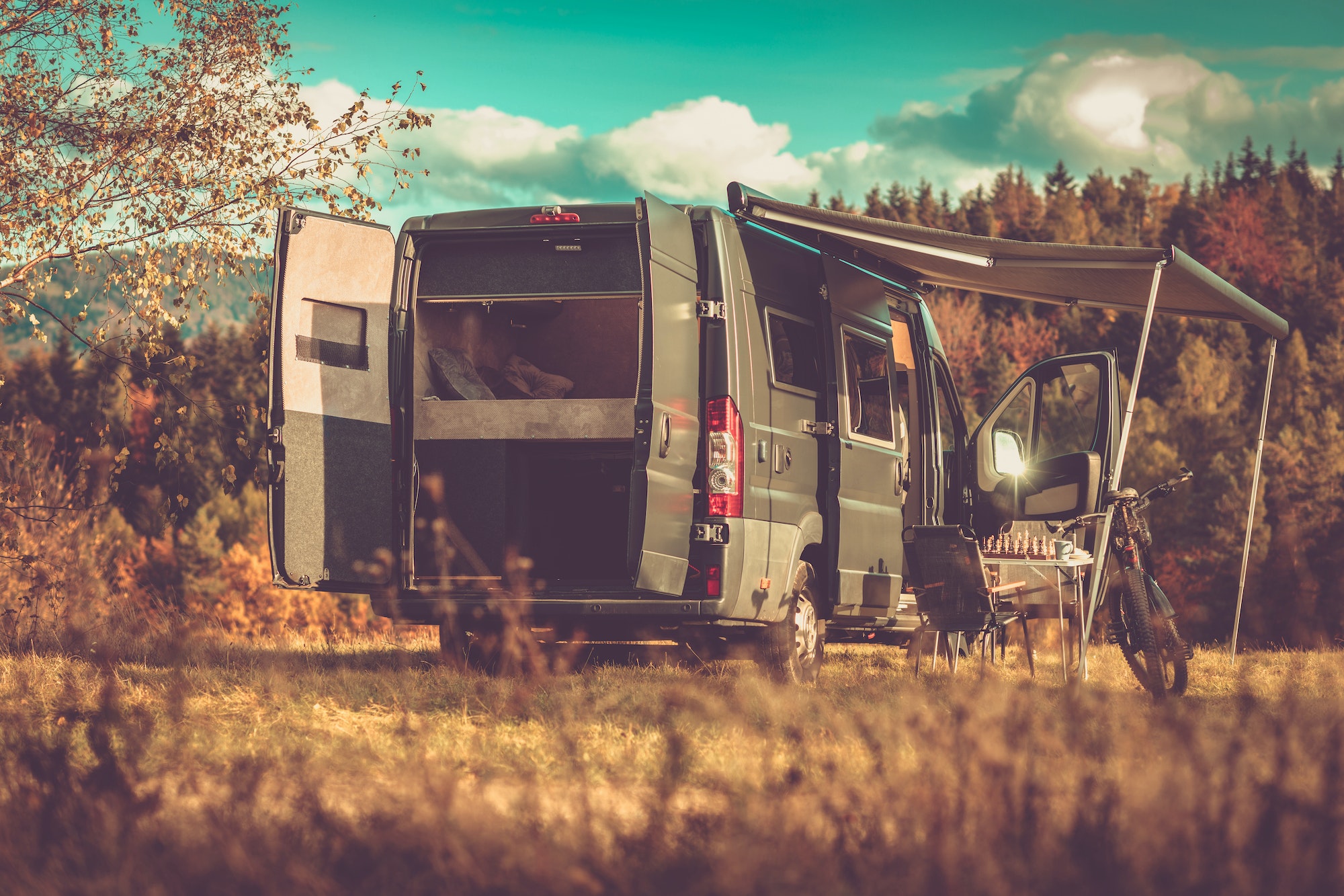 Camping Trailer Parked by the Deep Forest