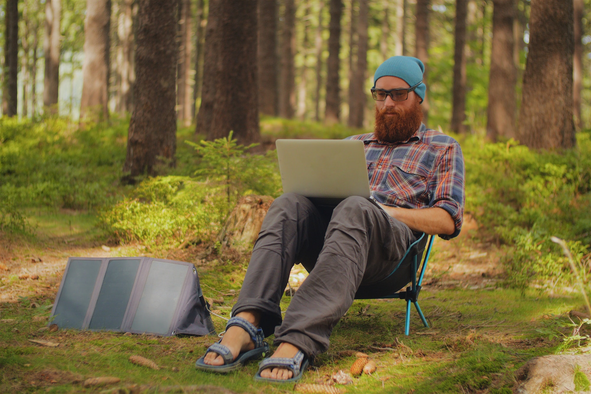 man using a laptop outdoors during a camping trip, digital nomad, work on the road