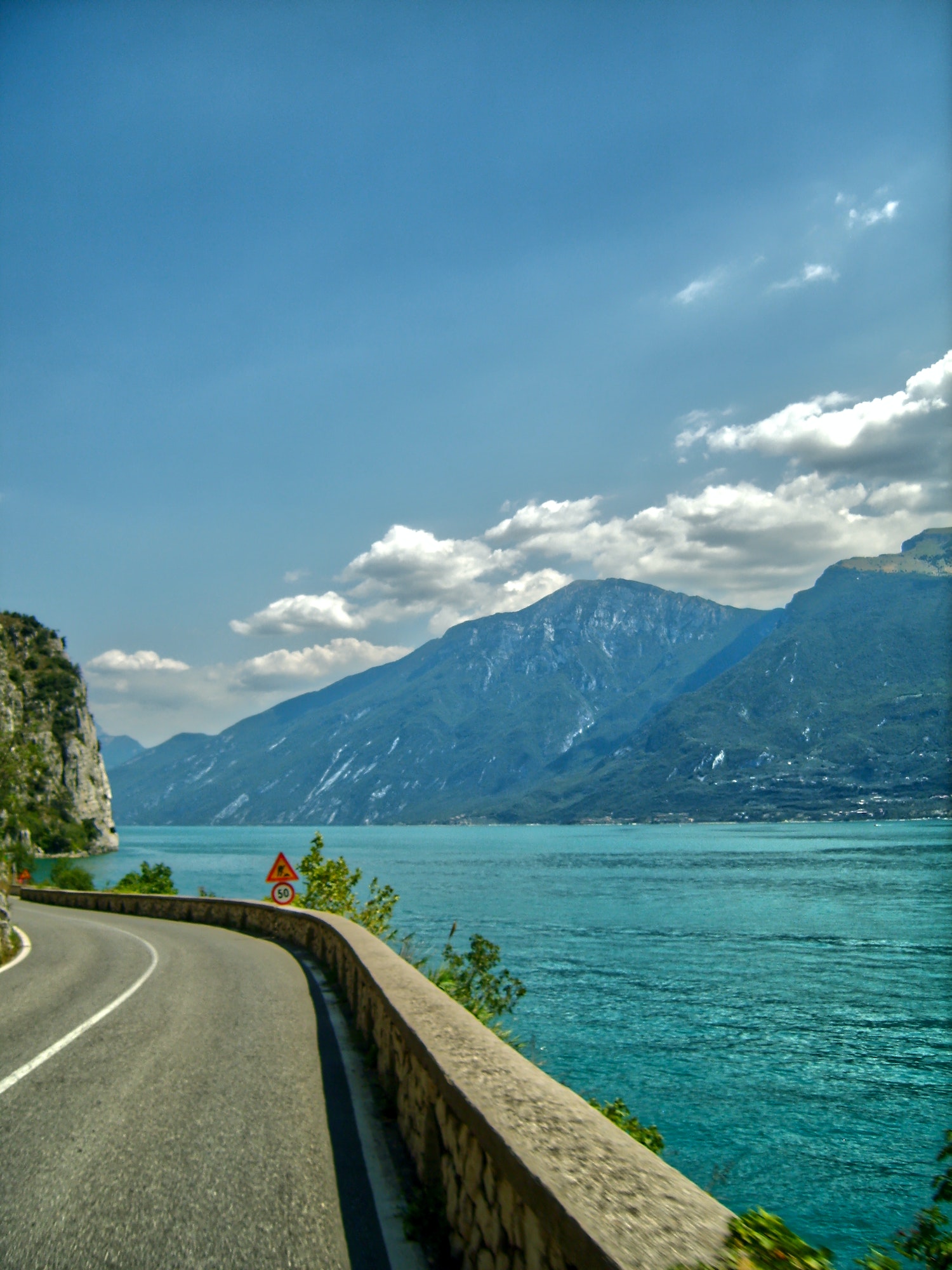 Vertical shot of a curving road going along Lake Garda in Italy
