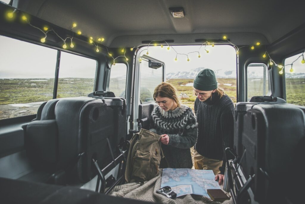 Couple making a wanderlust vacation, exploring iceland with their 4x4 jeep